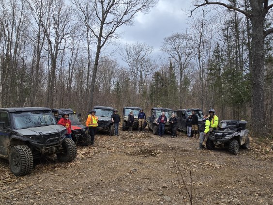 Group photo in front of their rides